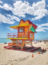 Lifeguard hut on beach against sky