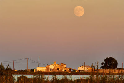Scenic view of moon against sky at sunset