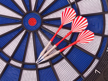 Close-up of darts on dartboard
