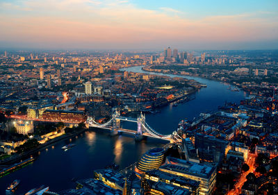 High angle view of illuminated city buildings at dusk