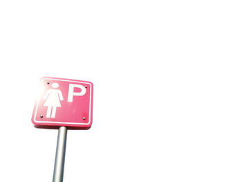 Low angle view of road sign against white background