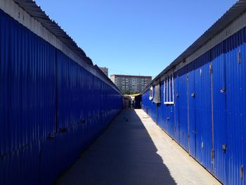 Walkway against blue sky