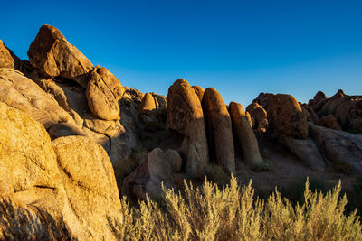 Rock formations against clear blue sky in california desert landscape