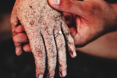 Close-up of couple holding dirty hands