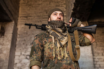 Portrait of serious middle eastern man with ak-47