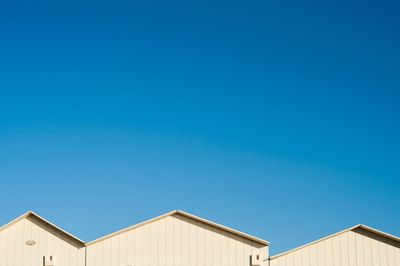 Low angle view of building against clear blue sky