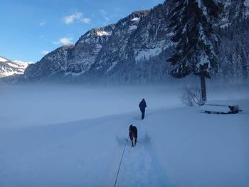 People standing on snow covered landscape