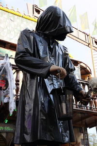 Rear view of man holding sculpture