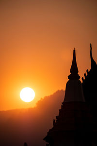 Silhouette temple against sky during sunset