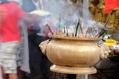 Incense sticks at buddhist shrine.