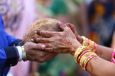 Midsection of couple holding hands