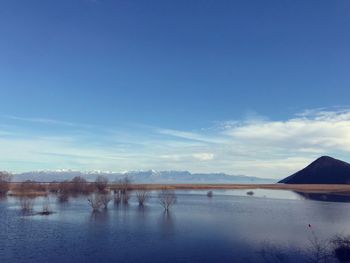 Scenic view of lake against blue sky