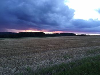 Scenic view of field against sky during sunset