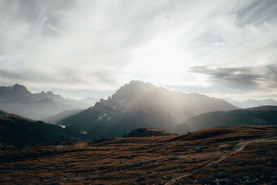 Scenic view of mountains against cloudy sky