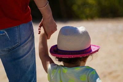 Rear view of man standing on footpath