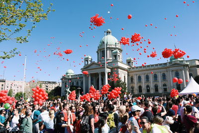 Group of people in front of building against sky