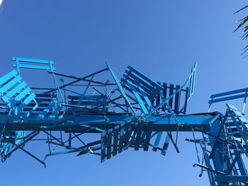 Low angle view of crane against blue sky