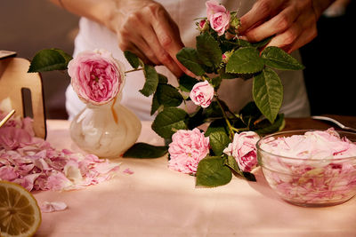 Girl preparing  roses petals aesthetic homemade natural tea rose jam - sugar, lemon, tea rose petals