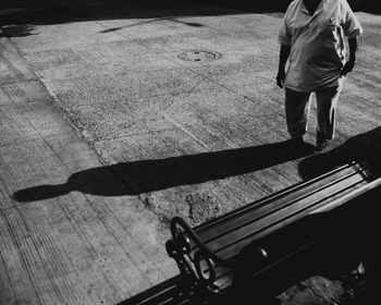 Low section of man standing on footpath