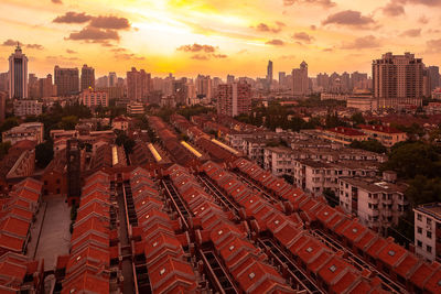 High angle view of buildings in city against sky during sunset