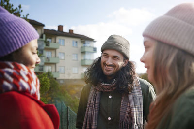 Smiling friends talking together