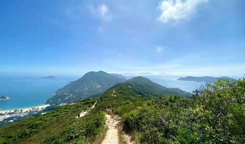 Scenic view of mountains against blue sky