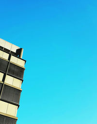 Low angle view of building against clear blue sky