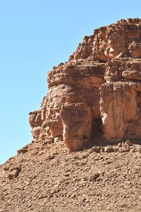 Low angle view of rock formation against sky