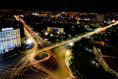 High angle view of illuminated city street and buildings at night