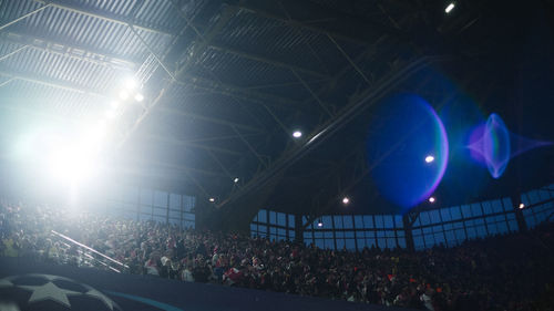 Crowd at illuminated music concert at night