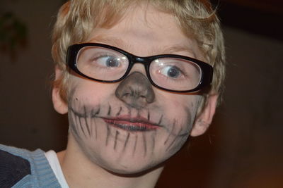 Close-up of boy with face paint wearing eyeglasses