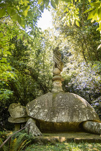 Statue amidst trees against plants