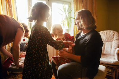 Rear view of women sitting at group of people