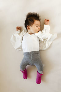 High angle view of cute baby girl sleeping on bed