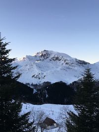 Scenic view of snowcapped mountains against clear sky