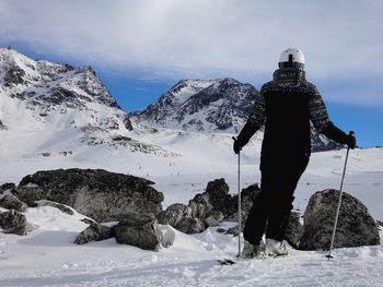 Woman with umbrella on snow covered landscape