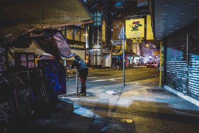 Man working in city at night