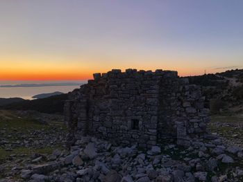 Ruins of building against sky during sunset