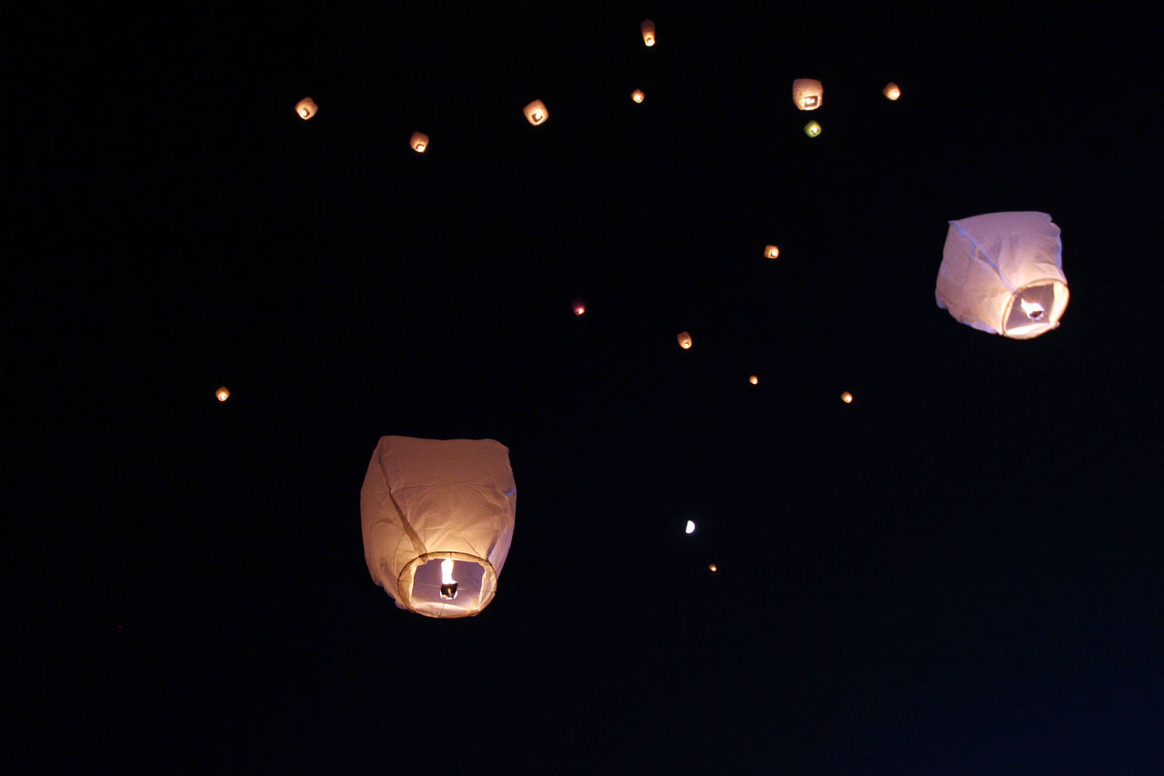 LOW ANGLE VIEW OF ILLUMINATED LANTERNS AT NIGHT