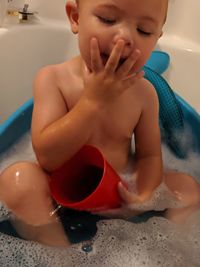 Midsection of shirtless baby boy in bathroom