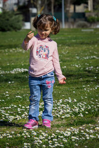 Full length of cute girl standing on grass