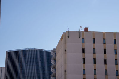 Low angle view of modern building against clear blue sky