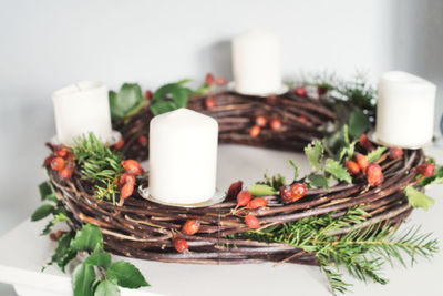 Close-up of christmas decorations and advent wreath on table