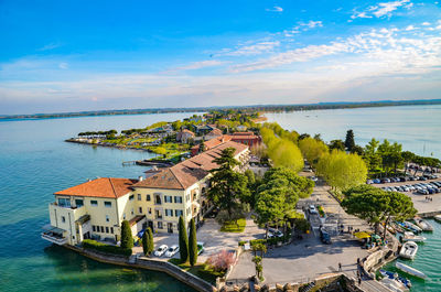 High angle view of buildings by sea against sky