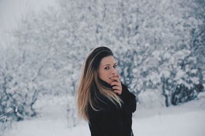 Young woman standing in snow