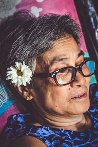 Close-up portrait of smiling woman wearing eyeglasses