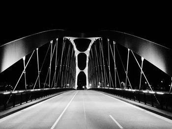 Illuminated tunnel at night
