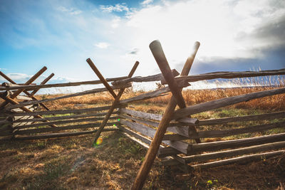 Fence on field against sky