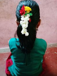 Midsection of woman standing by flowering plant