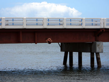 Full length of man on pier by sea against sky